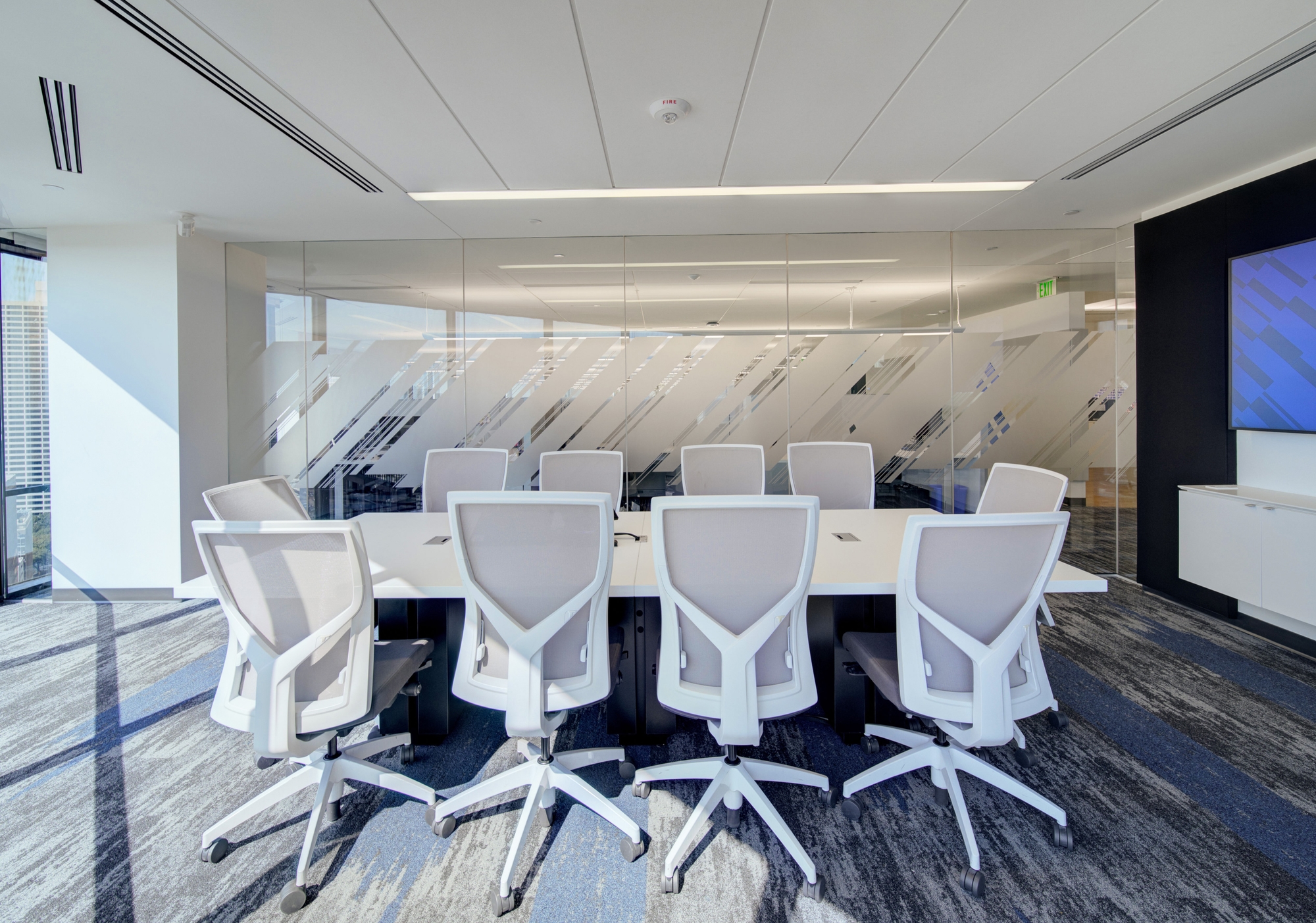 A brand graphic applied to glass conference room walls for privacy and branded visual identity