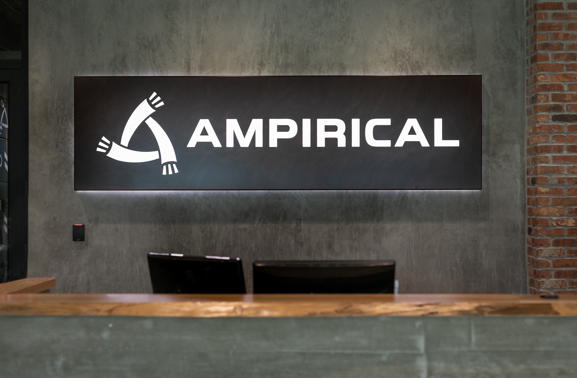 Customo illuminated logo in corportae office lobby dimensional logo