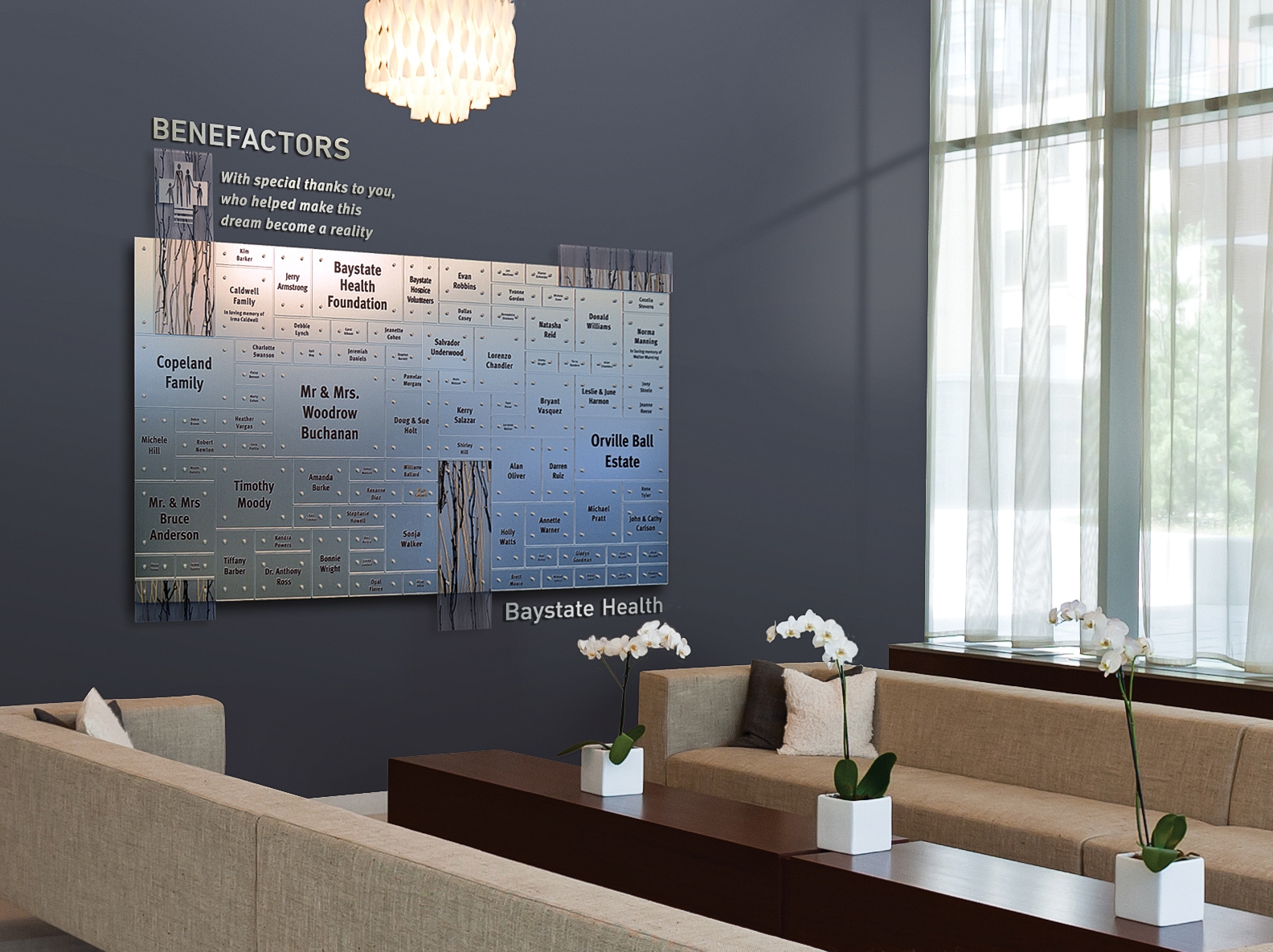 An elegant, understated healthcare donor recognition display featuring brushed stainless steel, clear acrylic, and encapsulated acrylic finishes installed in a contemporary hospital lounge