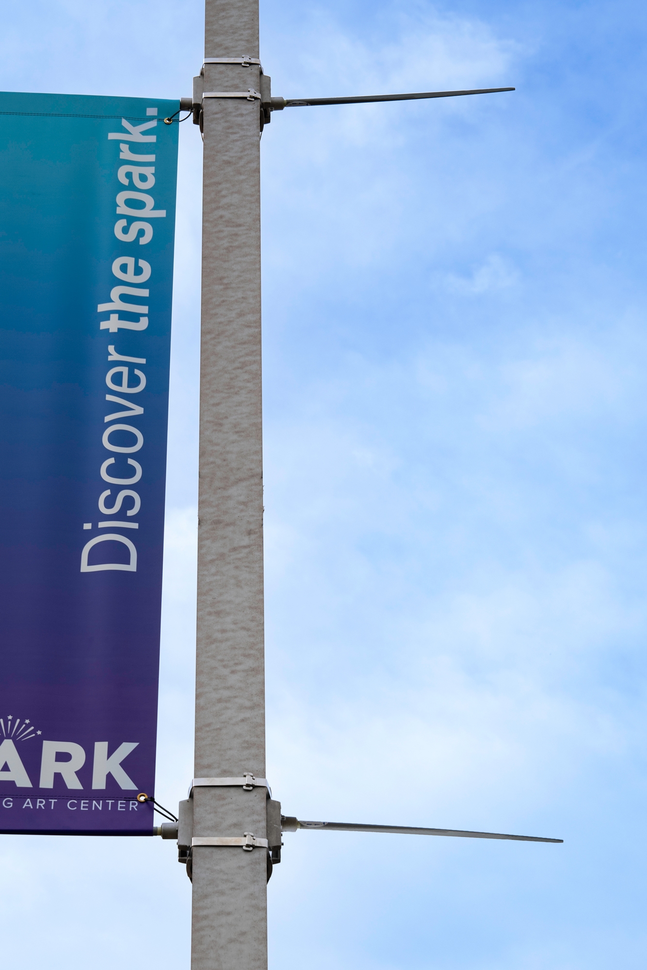An exterior pole banner and hardware revealing the canted poles that provide tension on the banner.