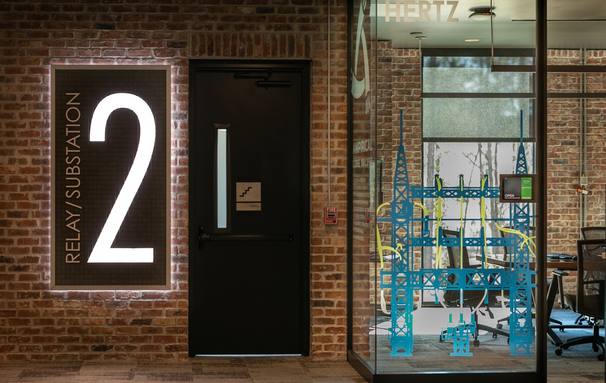 Custom fabricated level indicator designed to reflect a corporate office's brand along side the distressed and contemporary materials in the space.